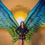 Girl in front of angle mural