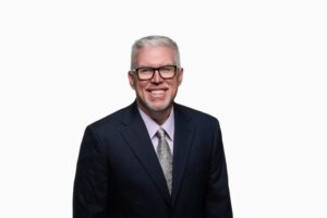 CEO headshot standing in front of white background