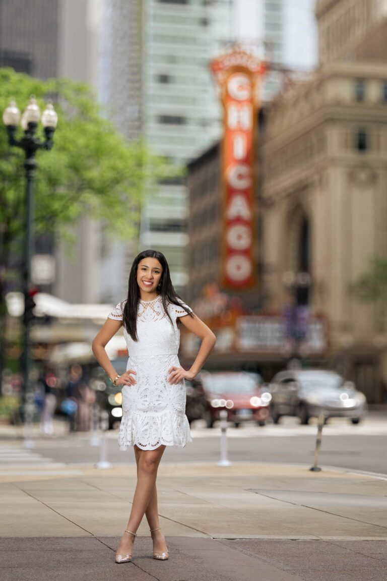 high school graduate standing on street sidewalk downtown chicago
