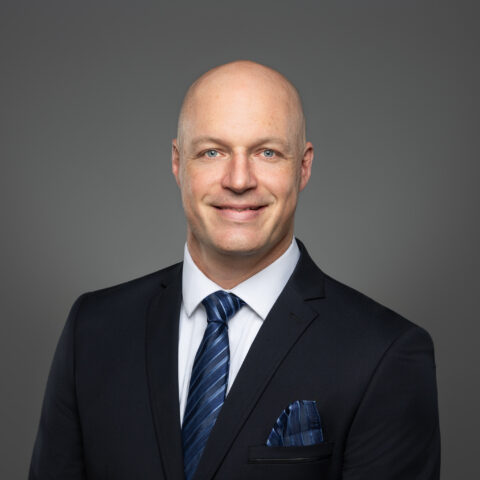 Professional headshot corporate business man against grey background